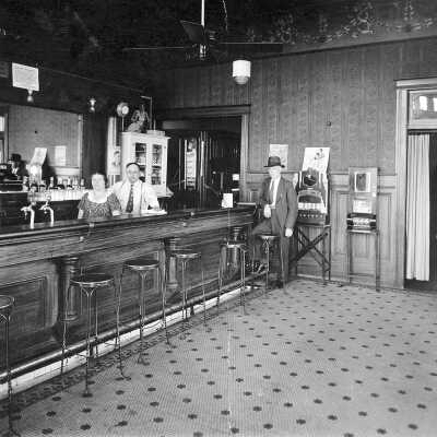 Trovatore Cafe interior #1 (Lunghi Perez): Maria and Joe Lunghi are behind the bar. Patrons could dine in private booths that had curtains for privacy. Joe’s son, Frank, moved the cafe across the street when he bought the Antlers Tavern.