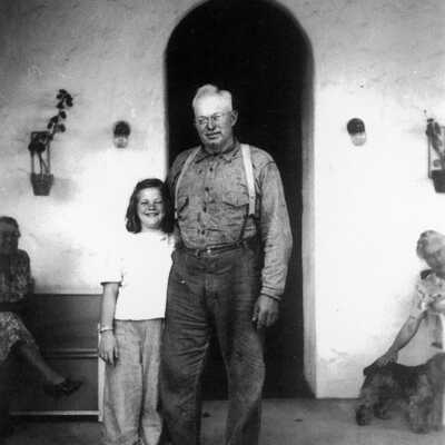 Mary Butler and Henry Ellerhorst 1945 (Mary Butler): Henry Ellerhorst with Mary Butler in 1945 in front of arched doorway.