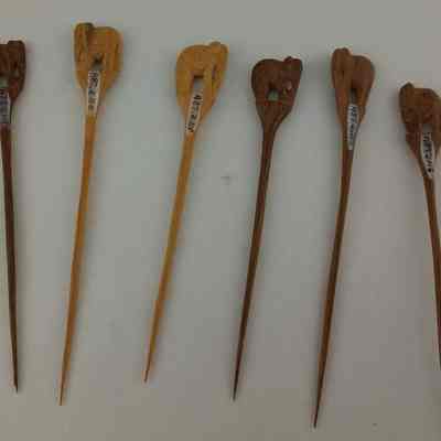 Six hand-carved wooden picks
