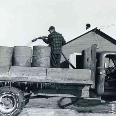 Man filling Barrels with Water