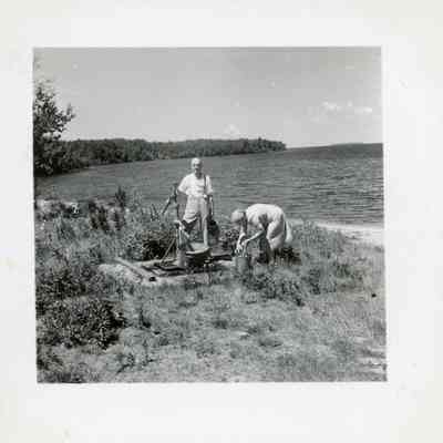 Frank and Laura Elston Pumping Water by the Lake