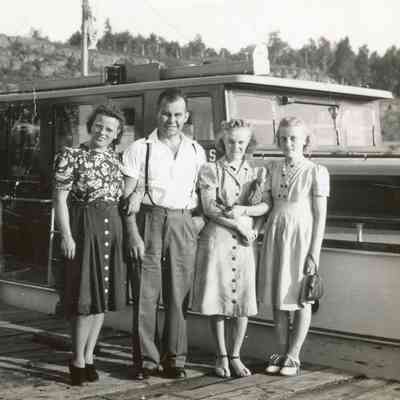 Family photo in front of small ship.