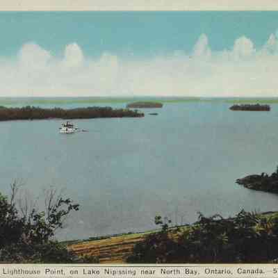 Steamer passing Lighthouse Point, on Lake Nipissing near North Bay, Ontario, Canada.