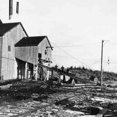Man Standing on Log Chute