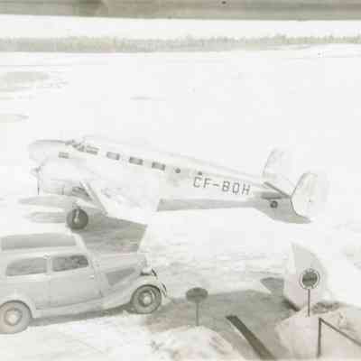 Car and Beechcraft airliner at North Bay Airport