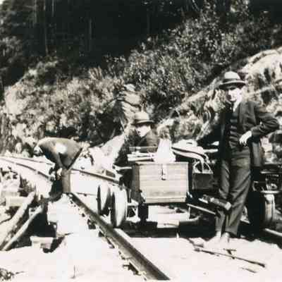 Three Men and Cart on Tracks