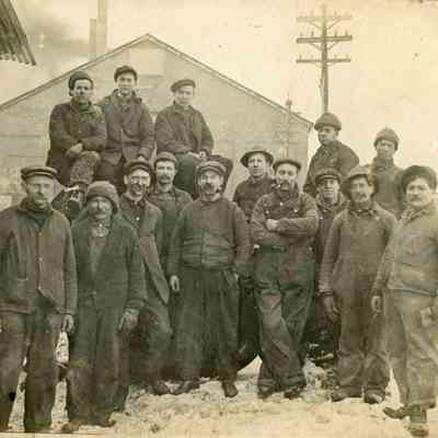 Group of Workers Outside of Wood Building