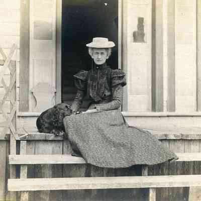 Woman with Dog on Steps of J.B. Smith & Sons