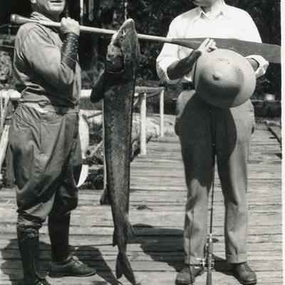 Two Men with a Sturgeon