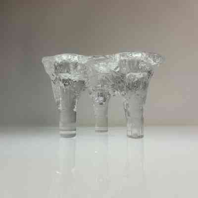 2.10.25d Kosta Boda Göran Wärff “Triple Icicle” Footed Candle Holder, Sweden, c. 1970s Carousel 1 Kosta Boda Göran Wärff “Triple Icicle” Footed Candle Holder, Sweden, c. 1970s Carousel 2 Kosta Boda Göran Wärff “Triple Icicle” Footed Candle Holder, Sweden, c. 1970s Carousel 3 Kosta Boda Göran Wärff “Triple Icicle” Footed Candle Holder, Sweden, c. 1970s Carousel 4 Kosta Boda Göran Wärff “Triple Icicle” Footed Candle Holder, Sweden, c. 1970s Carousel 5 Description MID–CENT–MAD Recycle, Reuse, ReLove! Please make an offer via the ‘Questions’ panel below Thank you for your support of a purely NZ-owned small business A sculptural Swedish art glass candle holder designed by Göran Wärff for Kosta Boda, Sweden, circa 1970s. Known as the “Triple Icicle”, this organically textured piece is cast in clear crystal glass, with three deeply indented wells for candles, supported by three solid conical legs. The surface is deeply textured to resemble melting ice or icicles, a design motif often associated with Wärff’s work for Kosta Boda. M E A S U R E S: Height: 9 cm Width: 13.5 cm Depth: 13 cm C O N D I T I O N: Presents well overall. A small chip is noted on one base leg, which is not visible in display position and does not affect structural integrity & is priced accordingly. P L E A S E N O T E: We recommend carefully reviewing the provided photos as they are integral to the item's description. We cannot be held liable for any damages that may occur during transit. ref: 2.10.25d Details Condition: Used Shipping & pick-up options Destination & description	Price Courier - Wellington $7.20 Courier - Wellington > Rural $14.01 Courier - Rest of North Island $9.25 Courier - Rest of North Island > Rural $17.09 Courier - South Island $13.20 Courier - South Island > Rural $21.47 Seller does not allow pick-ups Learn more about shipping & delivery options. Payment Options Pay instantly by card, Ping balance or saved bank account. What's Ping? Four fortnightly interest-free payments. What's Afterpay? Other options Cash, NZ Bank Deposit Questions & Answers thunderbirdvtg enter comment 500 characters remaining Do not use this feature to bypass the auction process or for commercial purposes. Abuse may result in suspension of your account. No questions have been asked! Kosta Boda Göran Wärff “Triple Icicle” Footed Candle Holder, Sweden, c. 1970s
