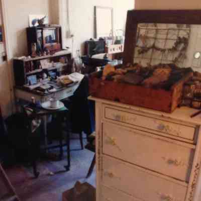 Untitled (Room with dressers, books, mirror, ladder)