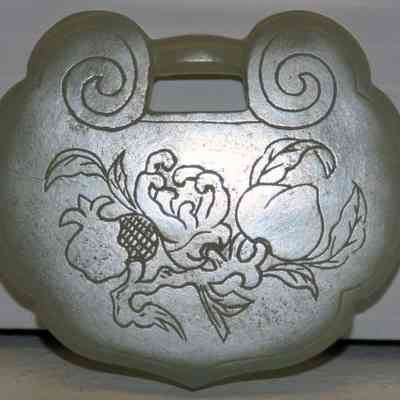 White jade pendant with etched script