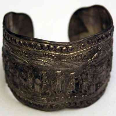 Silver repousse bracelet with procession scene