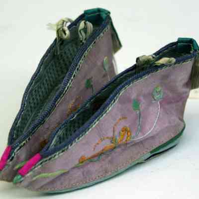 Pair of infant-sized, hand-embroidered, orchid silk slippers with accompanying socks