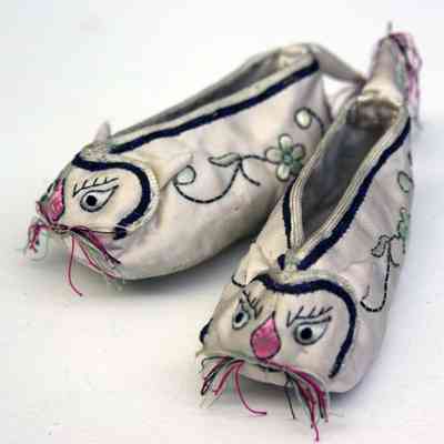 Pair of infant-sized, hand-embroidered, white silk slippers with cat motif
