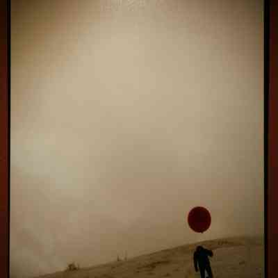 The Balloon (or If they are on the other side, they will see it rise like a moon and come running.