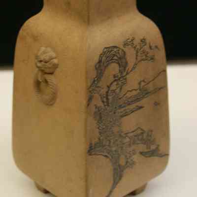 Brown unglazed stoneware vase with etched and stained designs