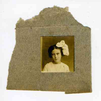 Photograph of a young girl with a large bow on her head