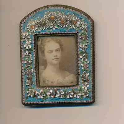 Photograph of a young woman in frame decorated with flowers