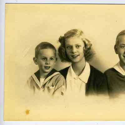 Studio photograph of a girl, a boy and a young boy