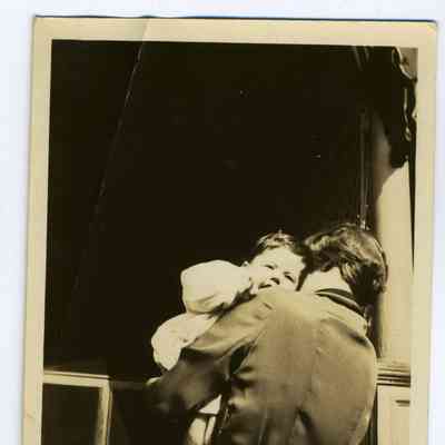 Photograph of a woman holding a Child