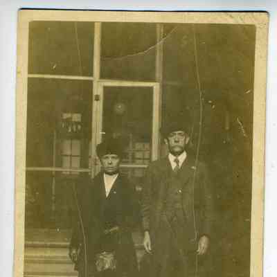 Photograph of an older woman and man in front of building
