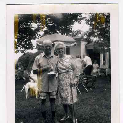 Photograph of a couple at a garden party