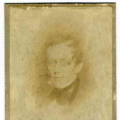 Studio photograph of a man with glasses
