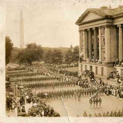 Photograph of a military parade with Washington Monument in the background