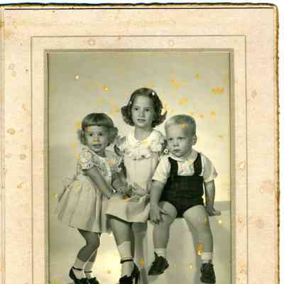 Studio photograph of two young girls and a young boy