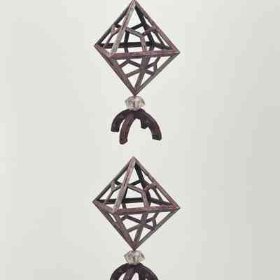 HC3. Fig. 7. Wooden octahedron with trisected faces hematite paint oyster shells and wooden support.