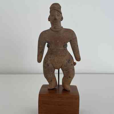 CLAY FIGURE ON WOODEN BLOCK