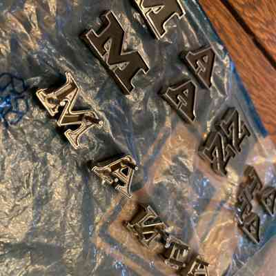 Appear to be opal manta letters (2 sets black, no post, 1 set silver, slightly smaller with posts), assume for the manta ray badging or prototype
