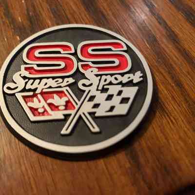 Round SS emblem with Crossflags model unknown possibly a door panel emblem 13/4"- 1 set of 2