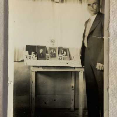 Harry Hunka in Front of Photographs