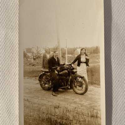 Man on a motorcycle with two Women