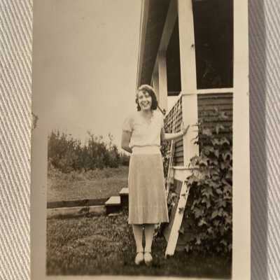 Woman beside a house