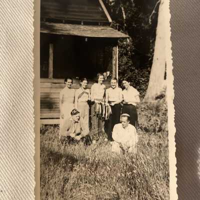 Group with fish in front of Cabin