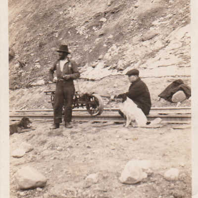 Two Men and Dog by Rail Tracks