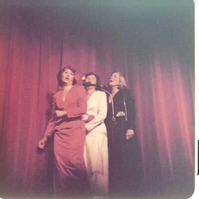 Photograph of performance at Lyceum Stunt Night by Joan Mooney, Jean Melton and Pat Clipson inpersonating the Andrew sisters. They also performed dressed in army fatigues.