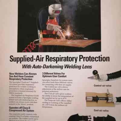 Supplied-air respiratory protection with auto-darkening welding lens
