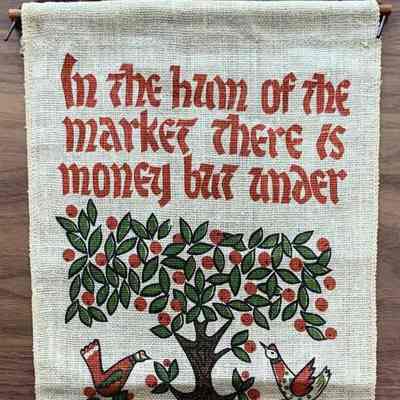 A Plowshares Kitchen Pockets wallhanging including the “Kitchen Notes” cookbook.