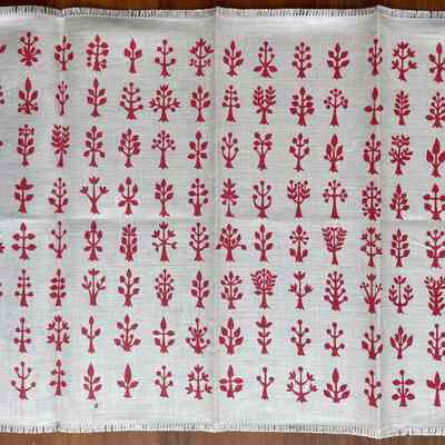 Napkin with pink print on white linen.