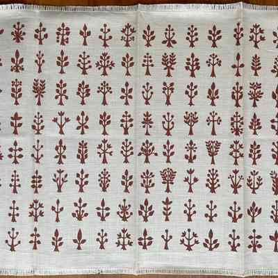 Napkin with coca print on white linen.