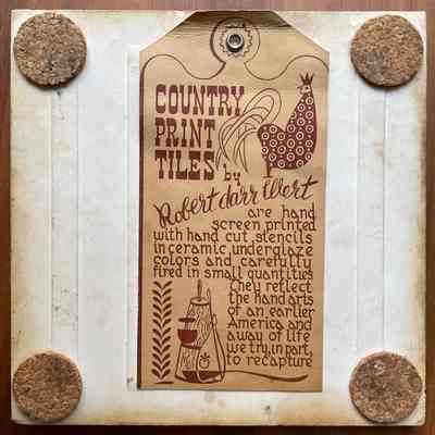 Tile back with Country Print Tiles label hanger and cork pads.