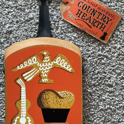 A Country Hearth tag attached to a Country Prints breadboard.