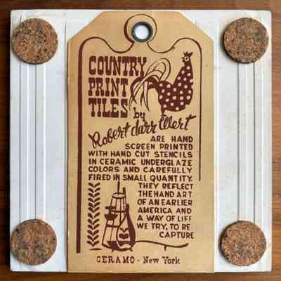 Tile back with cork pads and Country Prints Tiles label hanger.