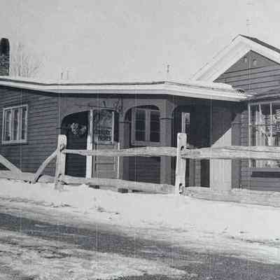 Wide shot of silkscreen workshop with sign at entrance.: Photocopy of image in the collection of Sara Leeper.