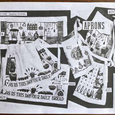 Daily Bread 426 Apron and matching table runner, lower left corner.: From, “Mat Sets by Robert Darr Wert/Country Prints”, p.6, c.1960.