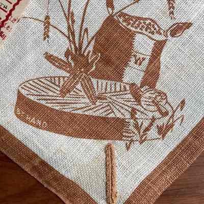 Detail, signature “W” and “BY HAND”, with millstone, corn and wheat.